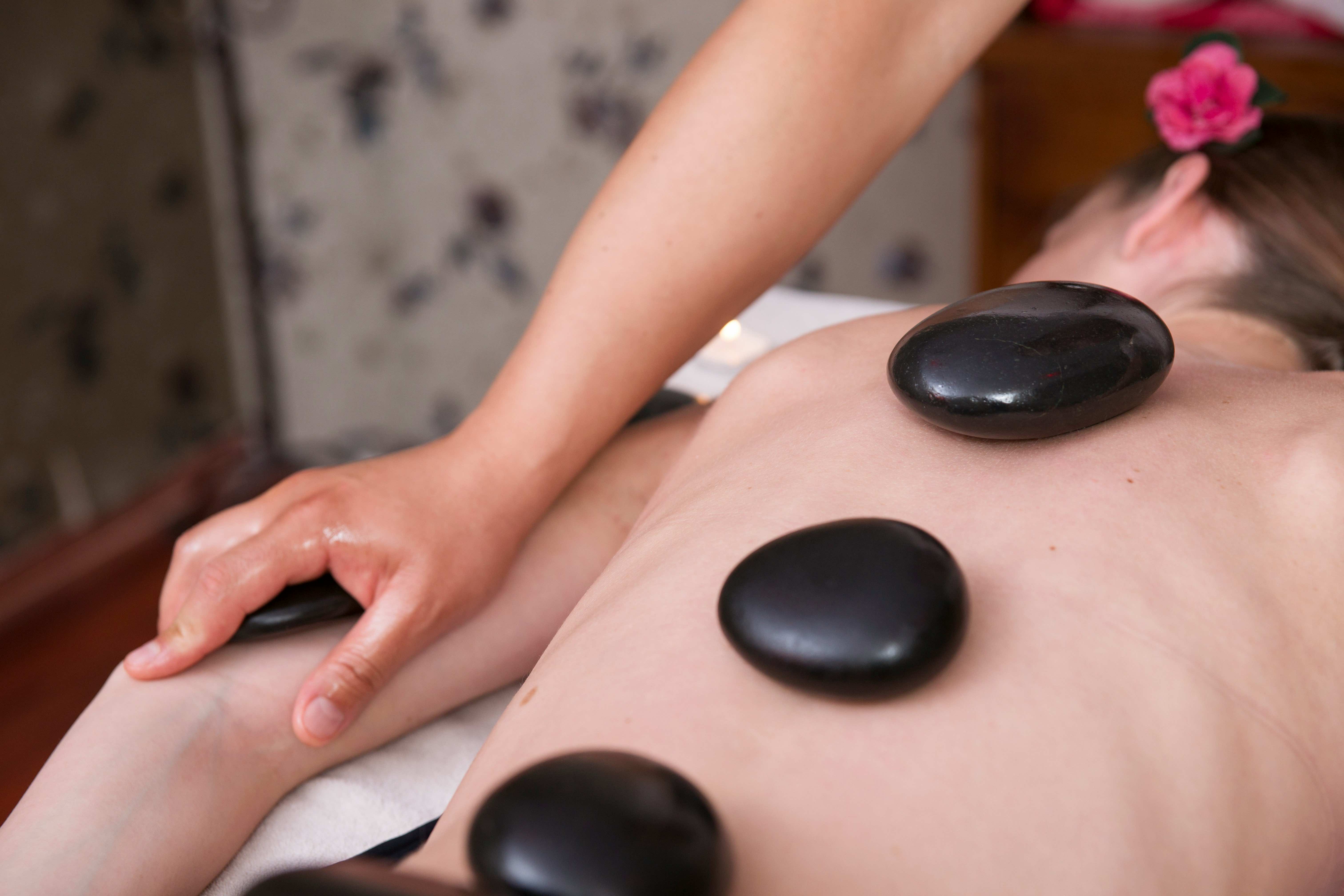 Therapeutic hot stone massage setup with heated basalt stones
